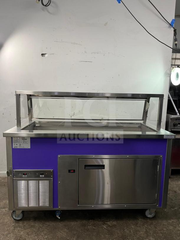 Brand new Delfield SCSC-60-EEP 60-inch refrigerated food prep table, stainless steel, purple accent, caster wheels.