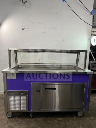 Brand new Delfield SCSC-60-EEP 60-inch refrigerated food prep table, stainless steel, purple accent, caster wheels.