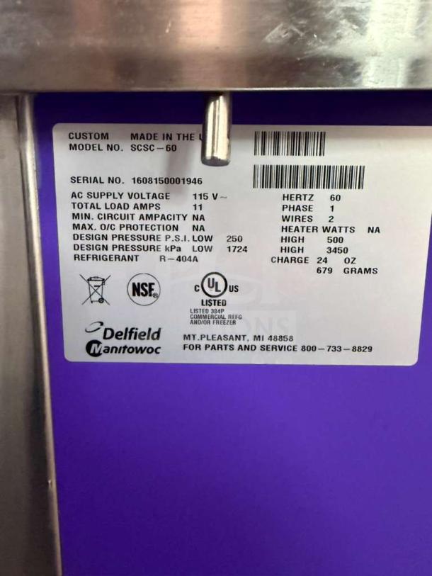 Brand new Delfield model SCSC-60-EFP 60-inch refrigerated food prep table label displays specifications, including serial number, voltage, refrigerant type R-404A, NSF certification, and manufacturing details.