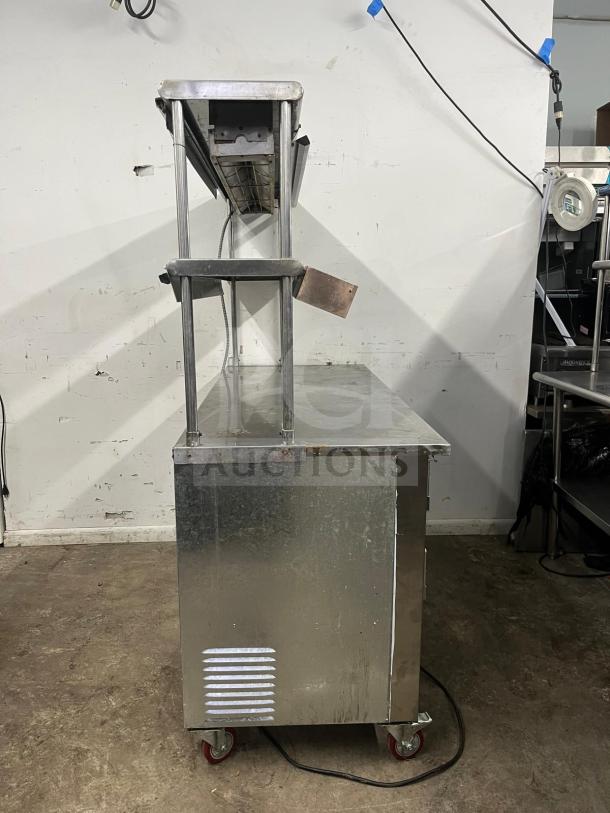 LEADER LB48 under counter refrigerator, stainless steel, 48", 2 full & 1 half door, dual shelves, heat lamp, wheels, used condition.