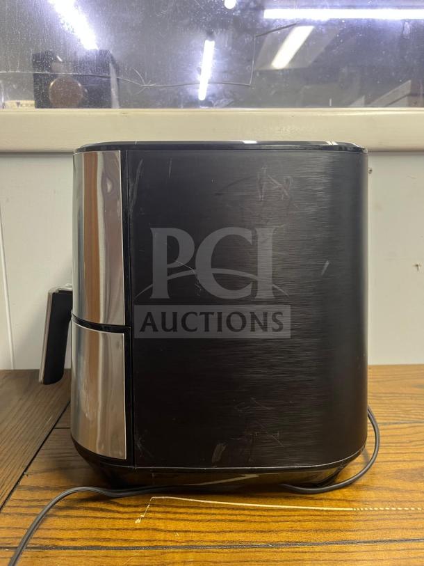 Insignia™ 5 Qt. Digital Air Fryer in stainless steel, side view, used condition with visible surface scratches.