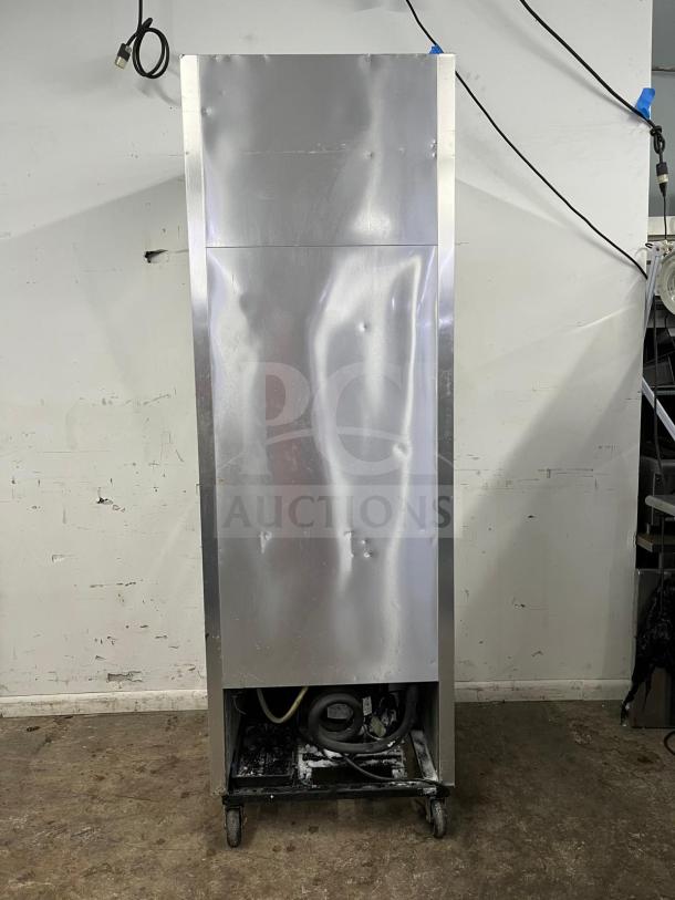 TRUE T-23-2 reach-in refrigerator with two left hinge solid doors, visible wear on metal surface, 27" width, 115V.