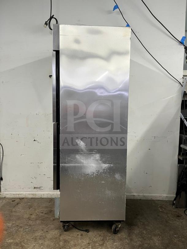 TRUE T-23-2 reach-in refrigerator, 27" with two solid left hinge doors, stainless steel, on casters, shows surface wear.