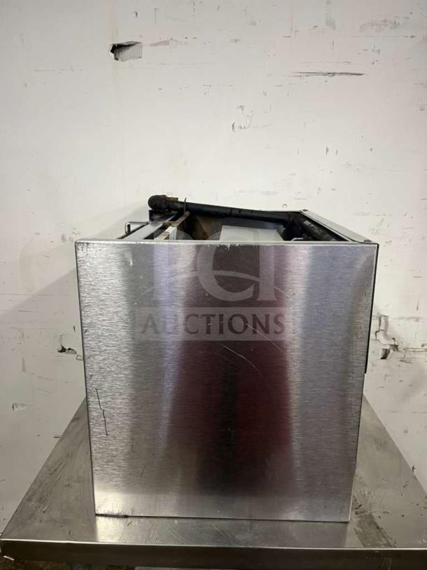 Jade Range JCM-24 24-inch gas cheesemelter, wall mount, infrared burners, 20,000 BTU, stainless steel, visible wear, side view.