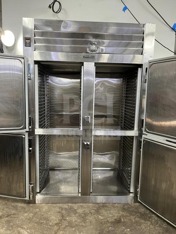 TRAULSEN RHT232NUT-HHS stainless steel refrigerator, 46 Cu. Ft., two-section, half-door, narrow reach-in, excellent condition.