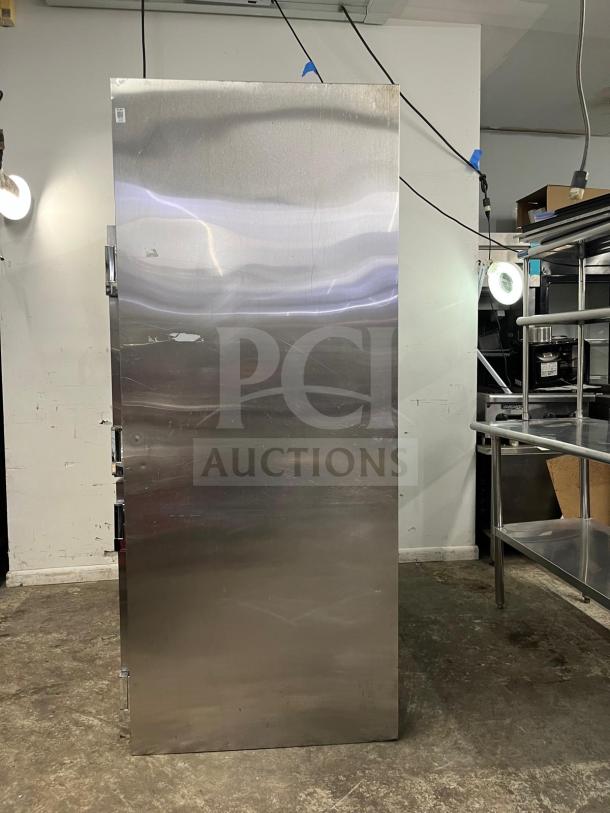 TRAULSEN RHT232NUT-HHS stainless steel 46 Cu. Ft. two-section narrow reach-in refrigerator. Half-door design, good condition.