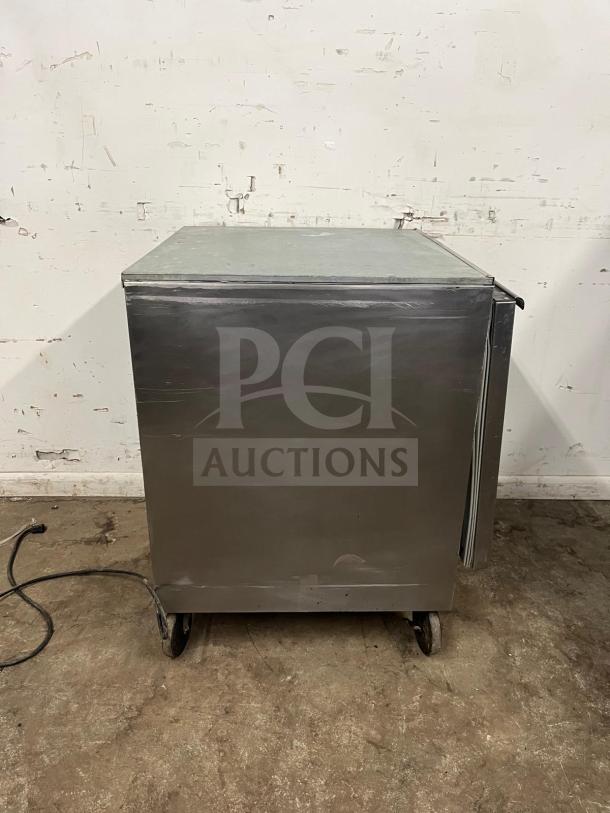 Beverage-Air undercounter refrigerator, 27" tall, stainless steel, wheeled base, visible wear, power cord attached.