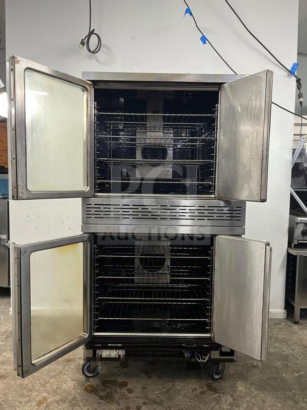 Imperial Double-Stack Convection Oven, open doors, stainless steel, two decks, used condition, on casters for mobility.