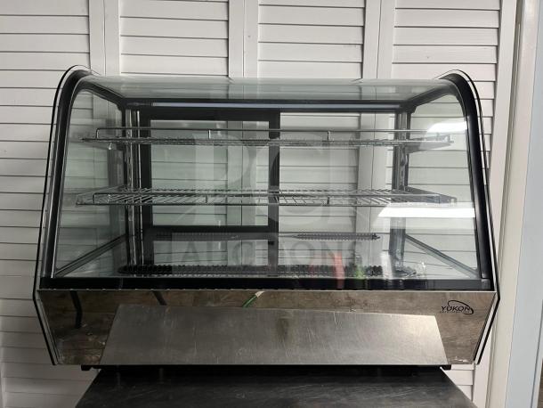 Yukon RTW-160 refrigerated display case with curved glass, two shelves, good condition, branded logo visible.