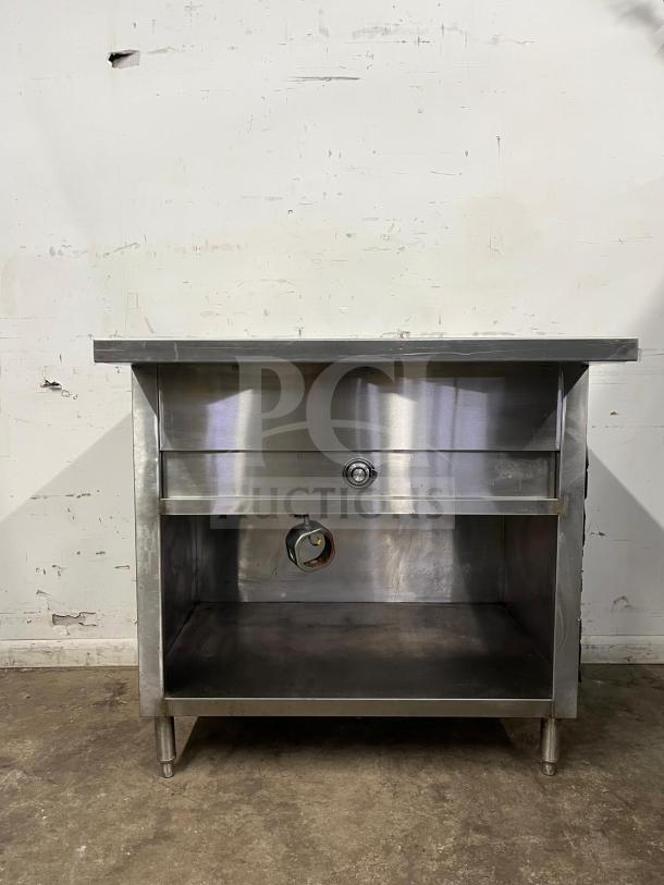 24" electric steam table, stainless steel, model STEAM TABLE. Shows wear, with temperature knob and storage shelf.