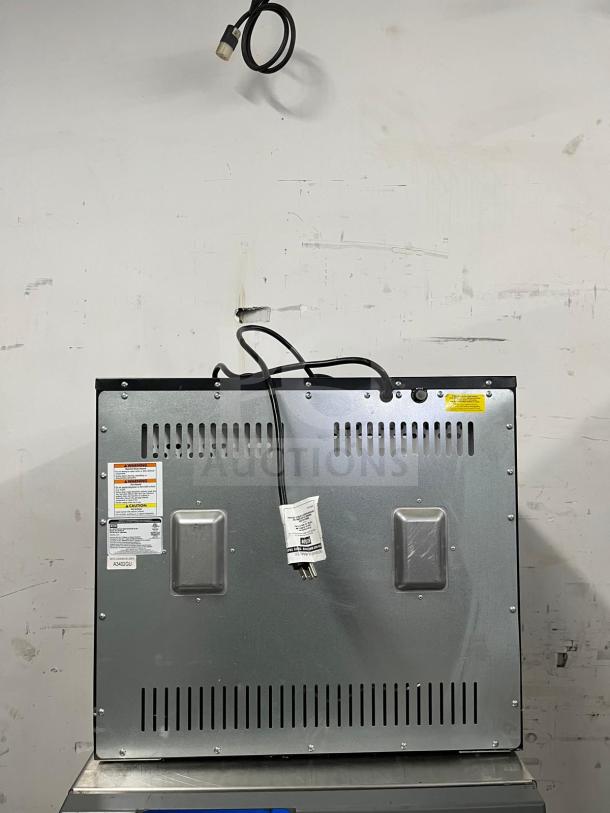 "Weston Pro-1200 12-tray Digital Dehydrator, brand new, model 80L. Features power cord, vented metal back, and caution labels."