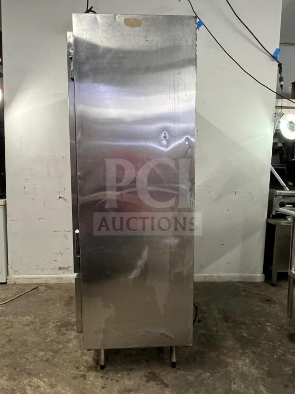 GLENCO SLA-28-S commercial freezer, stainless steel, two-door, upright model, sturdy build, minor surface wear.