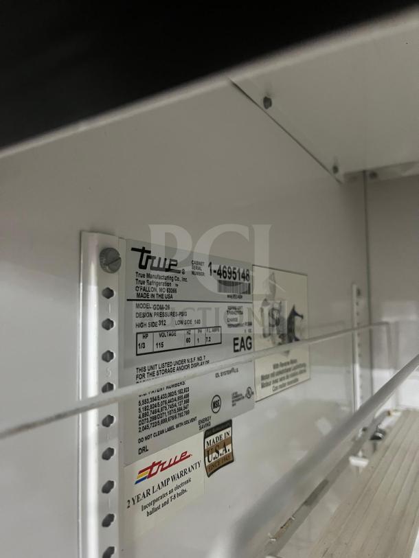 True GDM-26 refrigerator label showing model details, serial number, voltage, and pressure specs. Made in USA.