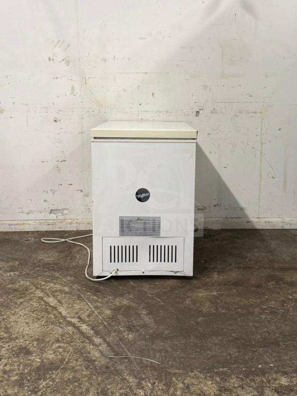 Alt text: MAGIC CHEF deep freezer, white, rectangular, front view. Visible power cord and manufacturer label on the front.