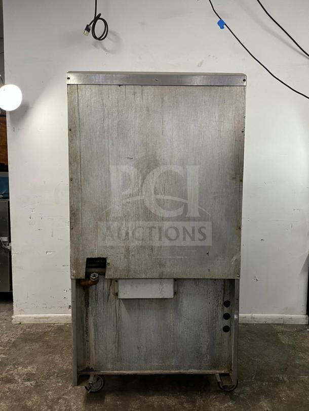 Jade Range JTRH-2HT-A Titan, heavy-duty gas range, commercial kitchen use. Visible wear, steel exterior, mounted on casters.