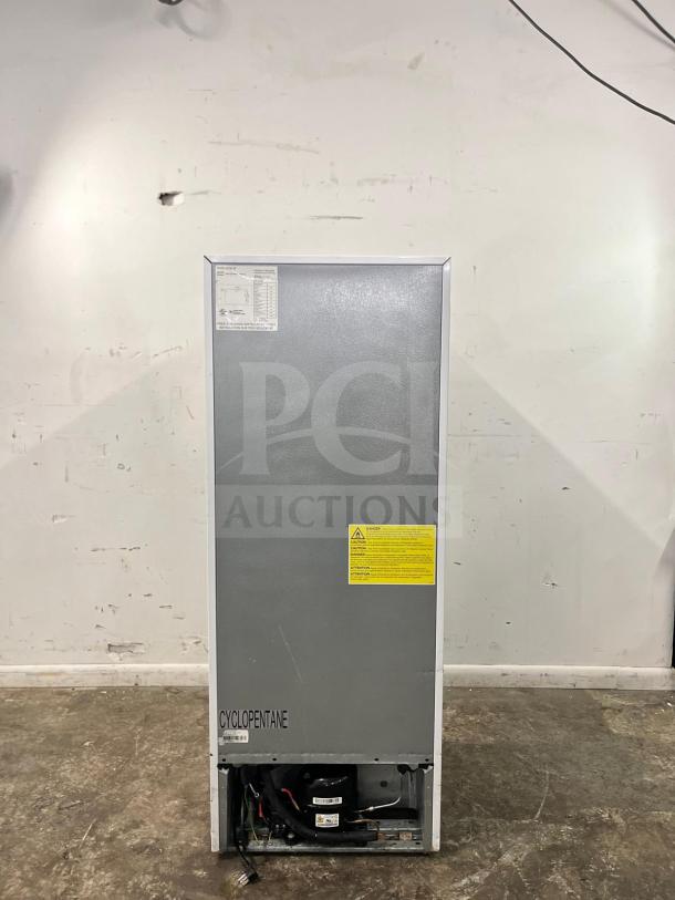 Insignia™ 7 Cu. Ft. Upright Convertible Freezer NS-UZ70WH4, versatile appliance, cyclopentane label, rear view.