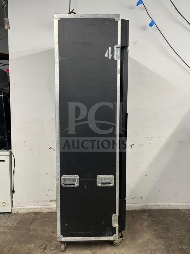 TRUE GDM-19T-LD refrigerated merchandiser in a travel case, black with metal edges, LED lighting, model number visible.