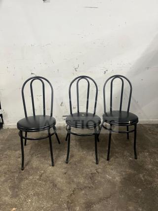 Three cafe dining chairs with black frames, padded vinyl seats. Minor wear visible. Perfect for a casual dining setting.