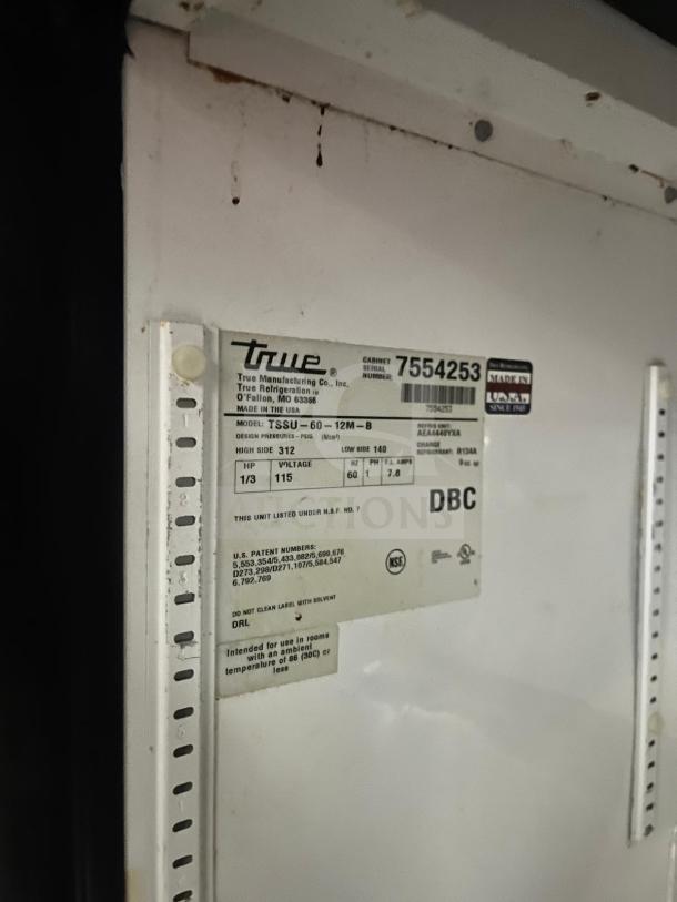 True TSSU-60-12M-B-HC refrigerated sandwich prep table label, showing model details, voltage, and NSF certification.
