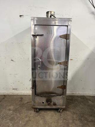 UNIVERSAL smoker oven, galvanized interior, 3 burners, 78" tall, stainless steel, visible wear, industrial design.