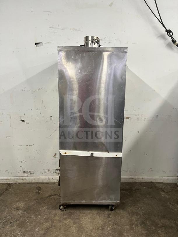 UNIVERSAL smoker oven, 78", galvanized interior, 3 burners, stainless steel, mobile wheels, good condition.