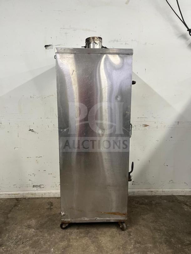 UNIVERSAL Smoker Oven, 78" height, galvanized interior, 3 burners, metallic exterior, visible wear, on wheels.