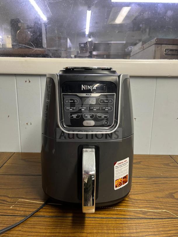 Ninja AF161 Air Fryer Max XL in good condition, featuring digital controls, and multiple cooking functions.