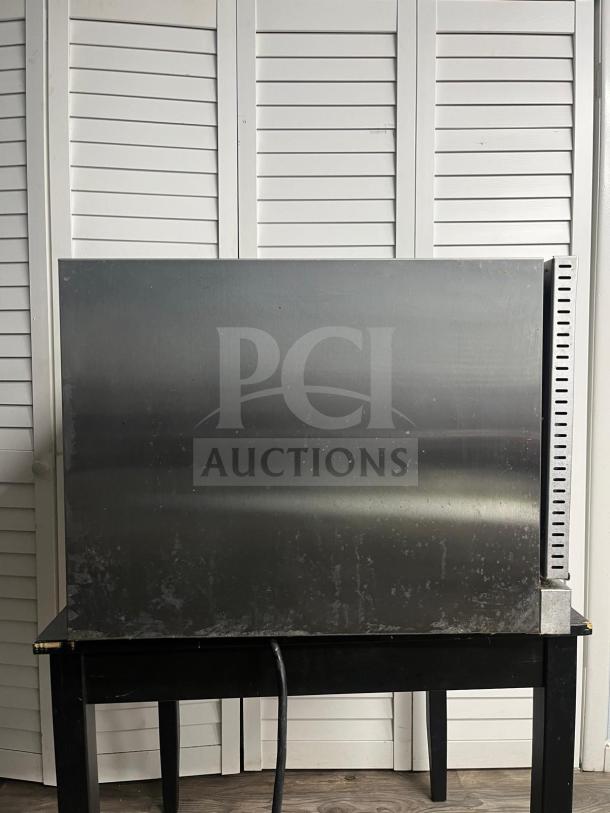 Avantco CO-38M countertop convection oven, 4.4 cu. ft., 208/240V, 3,500/4,600W, visible wear, back view.