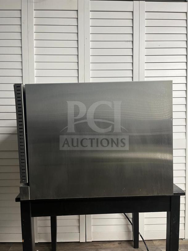 Avantco CO-38M countertop convection oven, full size, stainless steel, 4.4 cu. ft., 208/240V, used, on black table.