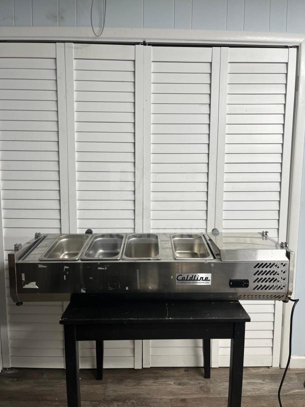 Coldline CTP60SS 60" refrigerated countertop salad bar, stainless steel, holds 6 pans, visible brand label, good condition.