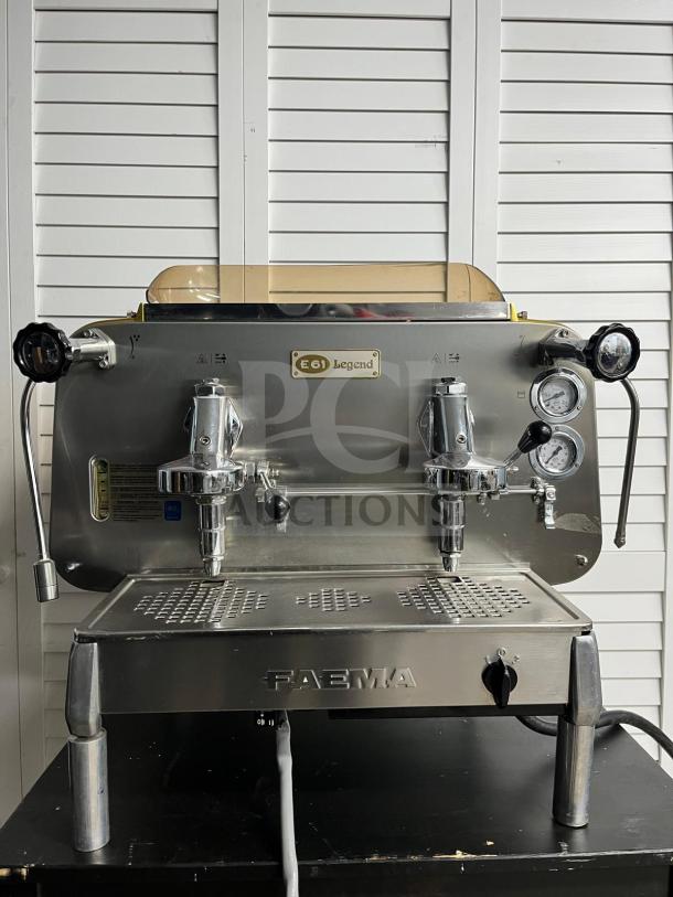 FAEMA E61 Legend semi-automatic espresso machine in excellent condition. Features dual group heads, pressure gauges, and chrome finish.