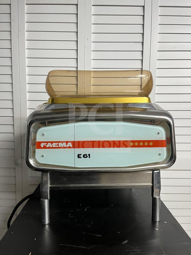 FAEMA E61 Legend semi-automatic espresso machine in excellent condition, featuring classic design with brand markings visible.
