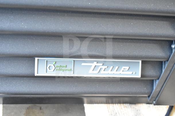 BRAND NEW SCRATCH AND DENT! 2025 True TVM-48SL-HC Commercial Refrigerated Merchandiser, black finish, LED lighting, 115 Volts, natural refrigerant label displayed.