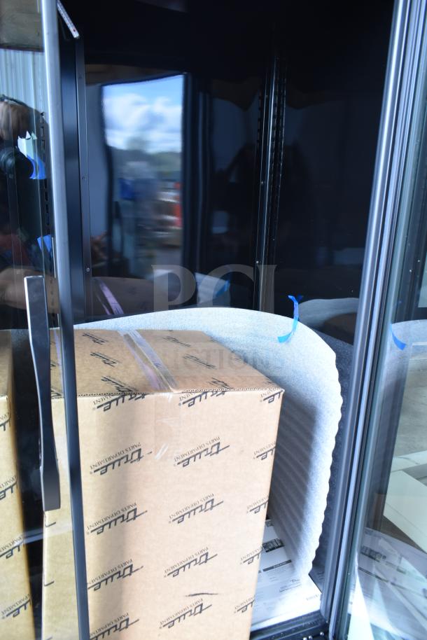 New True TVM-48SL-HC commercial glass door fridge, black, narrow profile, LED lighting, 115V, labeled box inside.