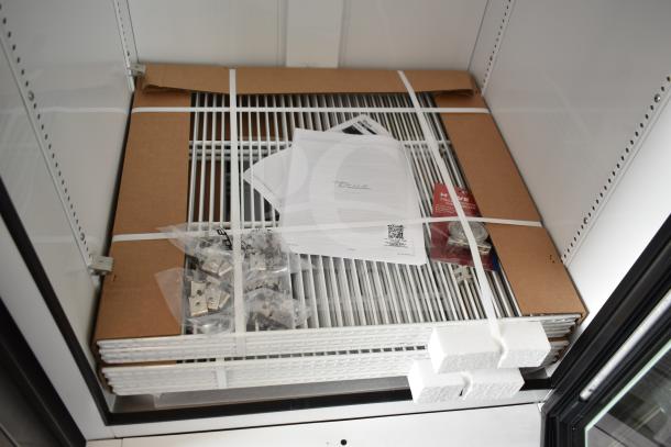 Brand new True TSCI-600R-G-PH commercial cooler with accessories. Features labels, manuals, and taped packaging. 115V, 1 phase.