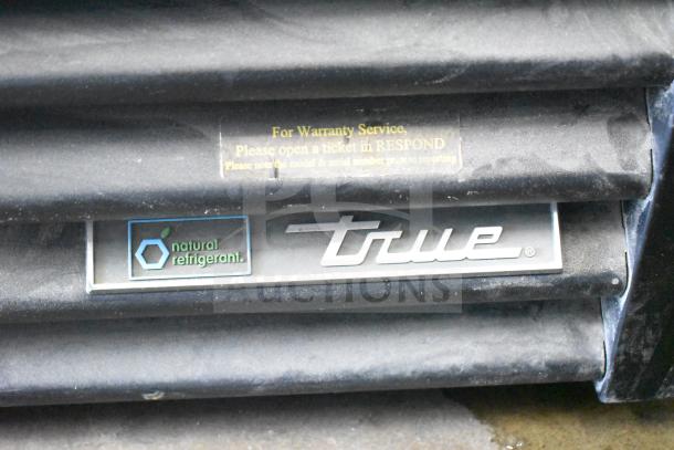 2016 True GDM-49F-HC commercial freezer tag, showing "natural refrigerant" and warranty service instructions.