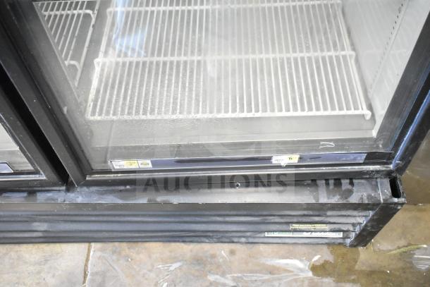 2016 True GDM-49F-HC commercial freezer, dual glass doors, visible shelving, moderate wear, 115/208-230V, 1 phase.