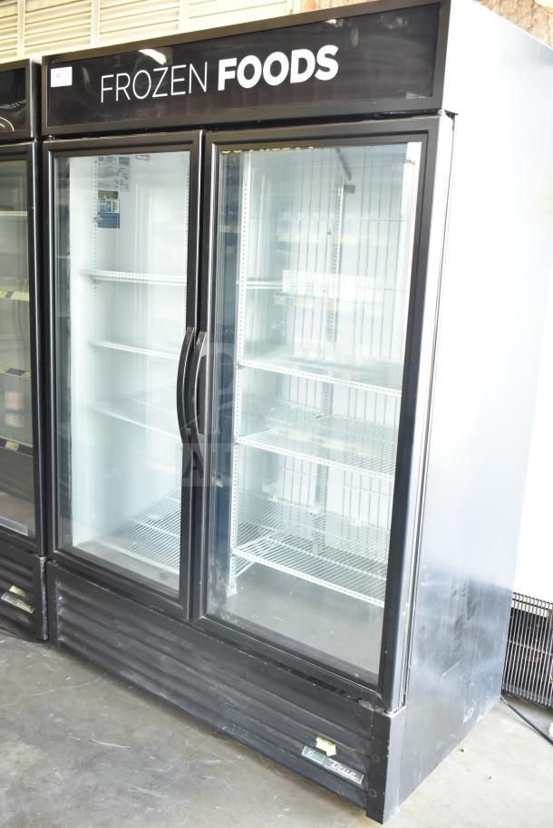 2019 True GDM-49F-HC 2-door reach-in freezer merchandiser, glass doors, black exterior, shelving visible, "Frozen Foods" label.