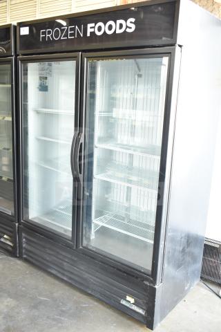 2019 True GDM-49F-HC 2-door reach-in freezer merchandiser, glass doors, black exterior, shelving visible, "Frozen Foods" label.
