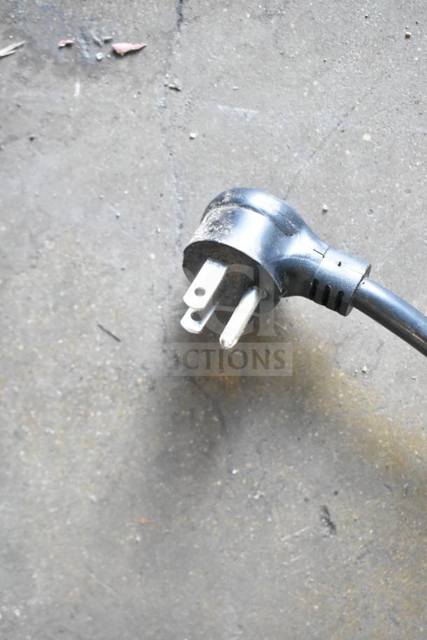 Power plug of 2021 True GDM-49-HC Commercial 2 Door Reach In Cooler, 115 Volts, 1 Phase, on a gray surface.