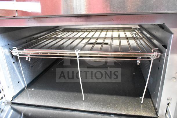 Interior of Vulcan 72SS-6B36GTN range's oven, showing wire rack and stainless steel finish, brand new condition.