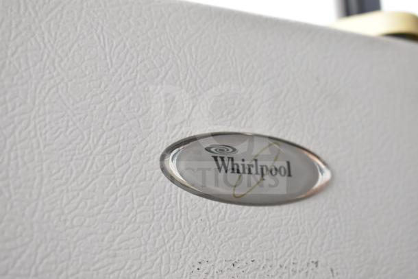 Whirlpool W1TXNMFWQ00 cooler with freezer, textured white finish, Whirlpool logo badge visible.