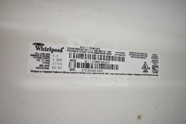 Whirlpool W1TXNMFWQ00 reach-in cooler with freezer label, model and serial numbers visible, indicating energy performance.