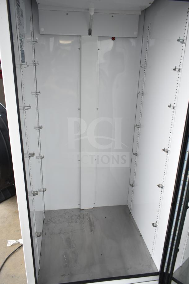 2021 True TSCI-600R-G-PH single door cooler merchandiser, empty interior, visible shelf brackets, 115V, 1 phase.