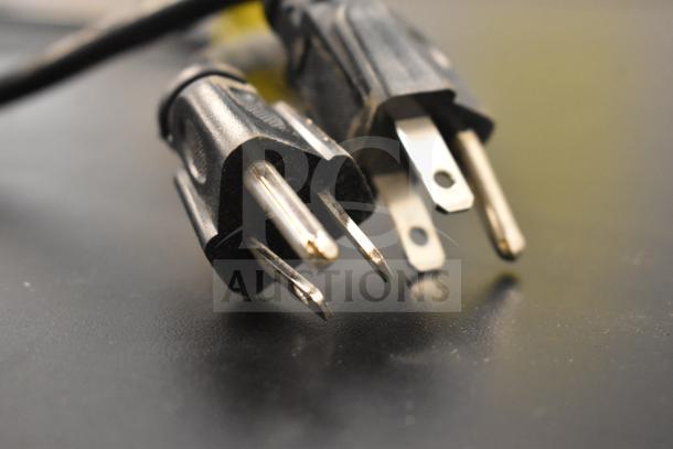 Close-up of power cords for IDW G4-H0234B cooler merchandiser, showing three-pronged plug for 110-120 volts, 1 phase.