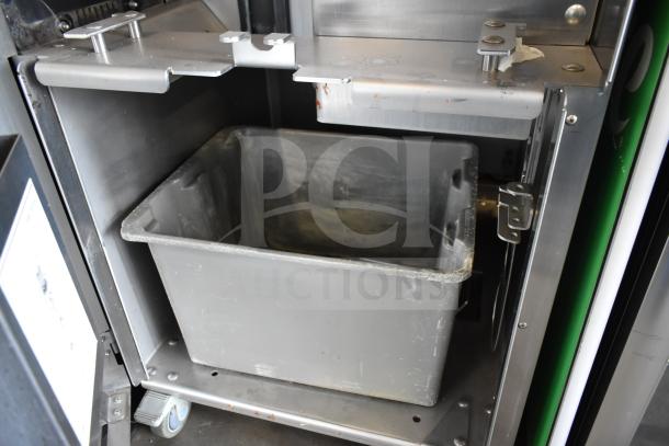 LATE MODEL JBT 2ND-GEN-MFJ-HE citrus juicer on casters, 115V, floor style, commercial use, includes gray bin.