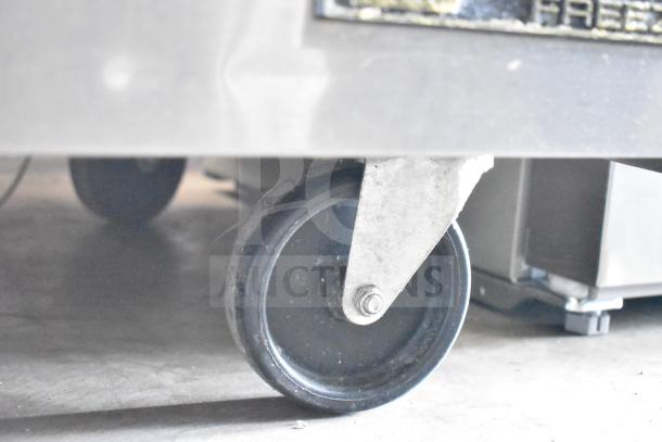 2016 True TWT-60F Commercial Work Top Freezer with dual doors and casters. Features 115V, 1 phase. Shown with focus on caster wheel.