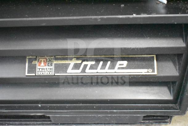 True GDM-12 cooler nameplate, showing brand logo and model details.
