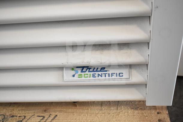 2021 True TSCI-600R-G-PH commercial cooler, 115V, 1 Phase, True Scientific branding on vent panel.