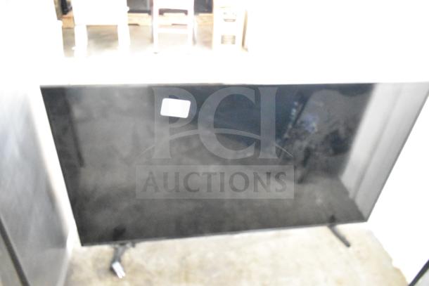 Two Samsung UN55NU6900B 55" TVs, stand-mounted, front view. Auction item, pickup required, no shipping.